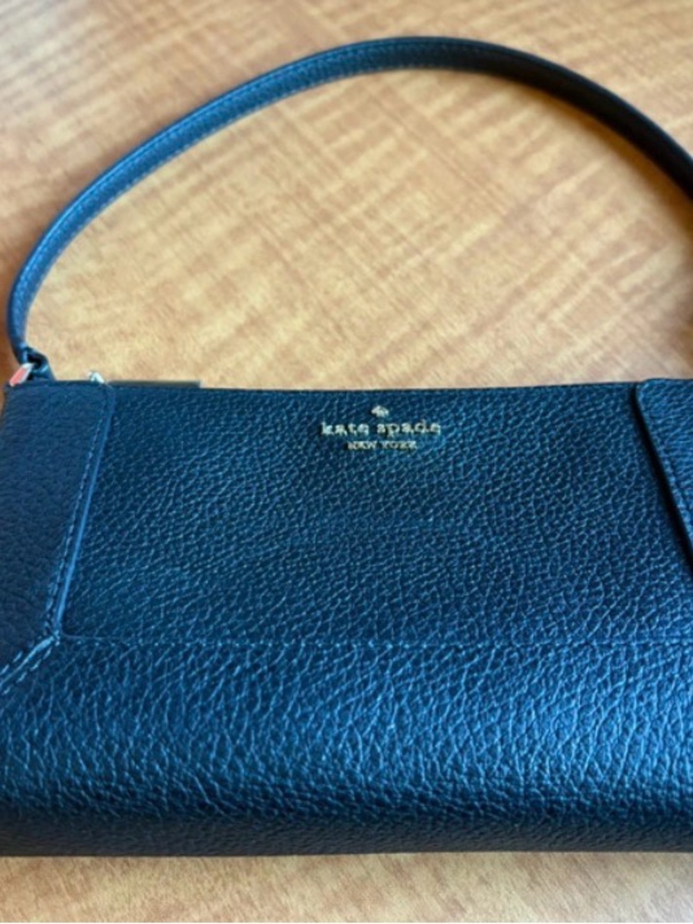 kate spade black pebbled leather wristlet with gold logo